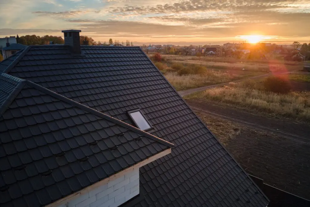 black standing seam metal roof at sunset