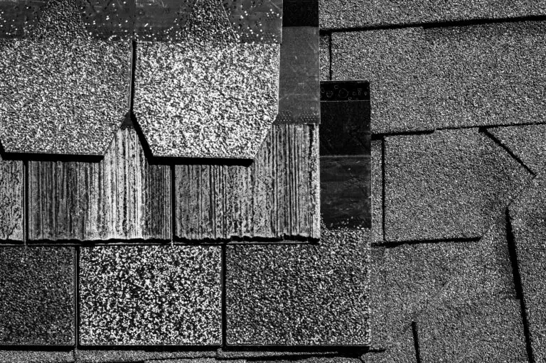 damaged asphalt shingles showing granule loss and wear