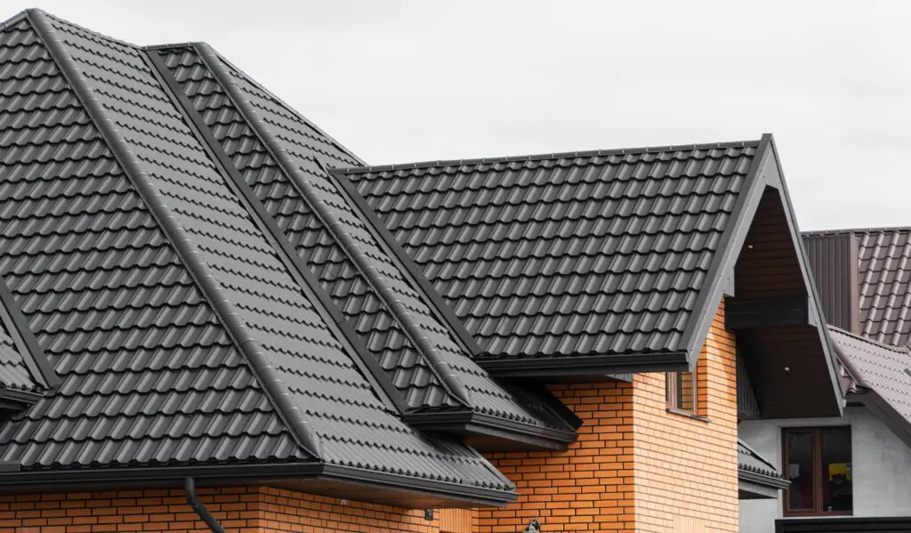 dark gray tile roofing system on residential property
