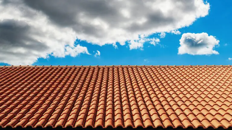 large residential clay tile roof under blue sky
